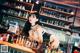 A woman in lingerie sitting at a bar.