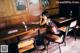 A woman sitting at a table in a restaurant.